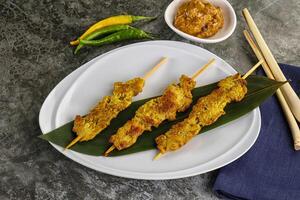 Thai meat skewer Satay with sauce photo