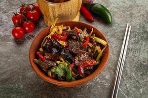 Asian wok with noodle, vegetables and beef photo