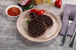 Grilled burger cutlet with sauce photo