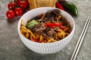 Asian wok with noodle, vegetables and beef photo