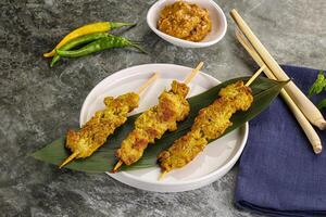 Thai meat skewer Satay with sauce photo