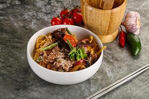 Asian wok with noodle, vegetables and beef photo