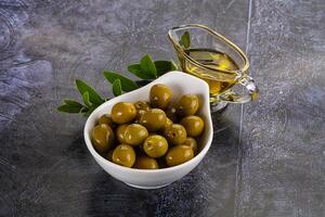 Ripe tasty green olives with branch photo