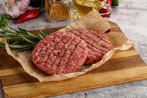 Raw burger cutlet for grill photo