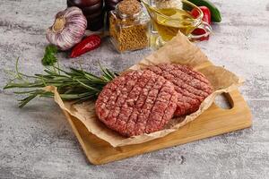 Raw burger cutlet for grill photo