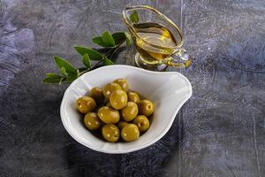 Ripe tasty green olives with branch photo