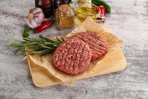 Raw burger cutlet for grill photo