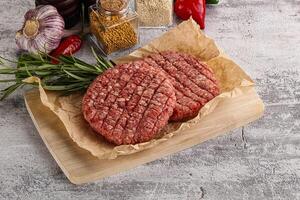 Raw burger cutlet for grill photo