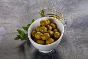 Ripe tasty green olives with branch photo