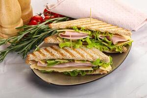 Homemade club sandwich with ham and cheese photo