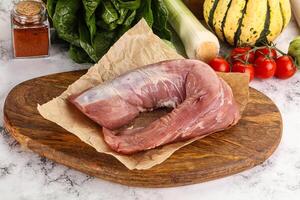 Uncooked raw pork tenderloin with spices photo