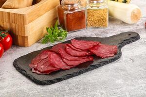 Smoked beef meat - Pastrami slices photo