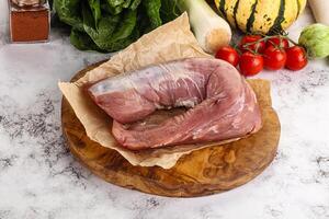 Uncooked raw pork tenderloin with spices photo