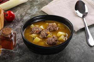 Soup with beef meatball and vegetables photo