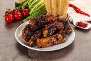 Grilled pork ribs in barbecue sauce photo