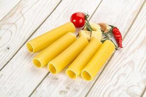 Raw uncooked Italian pasta Cannelloni photo