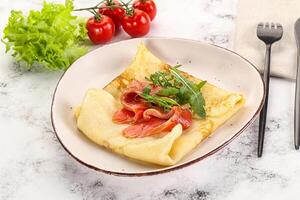 Russian pancake with salmon fish photo