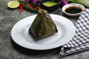 Asian cuisine - rice with filling in banana leaf photo