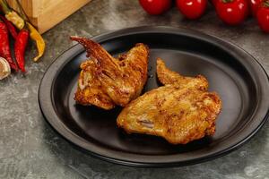 Tasty roasted chicken wing with spices photo