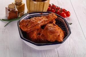 Raw turkey shoulder wing in Indian tandoori marinade photo