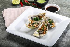 Open half oysters with green onion photo