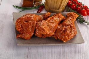 Raw turkey shoulder wing in Indian tandoori marinade photo