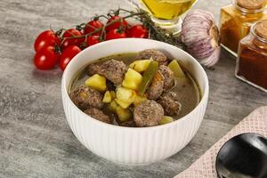 Soup with meatball and potato photo