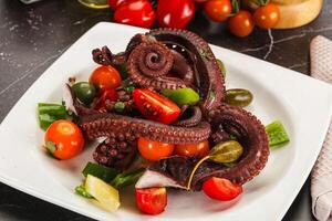 Salad with octopus tentacle and vegetables photo