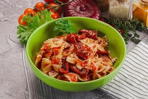Italian pasta with dry tomato photo