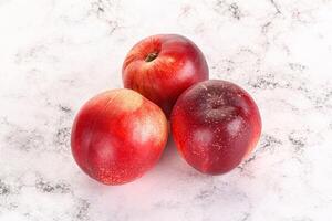 Ripe sweet juicy nectarines heap photo