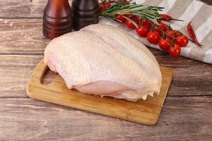 Raw chicken breast with bone photo