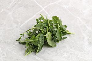 Green Arugula heap over background photo