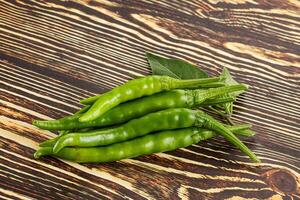 Spicy green chili pepper heap photo
