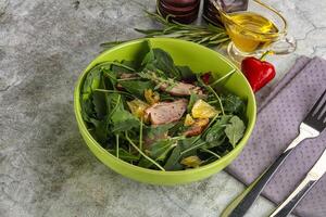 Salad with roasted duck and orange photo