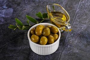 Ripe tasty green olives with branch photo