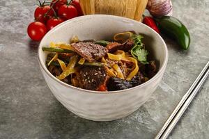 Asian wok with noodle, vegetables and beef photo