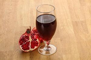 Sweet pomegranate juice in glass photo