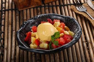 Sweet fruit salad with ice cream photo