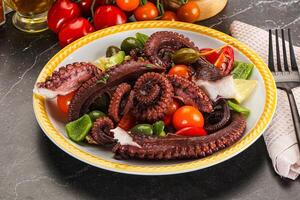 Salad with octopus tentacle and vegetables photo