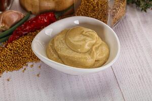 Dijon mustard sauce in the bowl photo