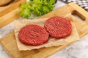 Raw beef burger cutlet for grill photo
