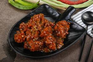 Manchurian chicken with sauce and spices photo