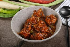 Manchurian chicken with sauce and spices photo