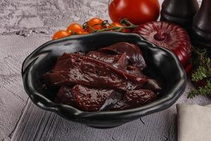 Raw beef liver slices for cooking photo