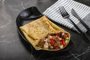 Pancake with chicken and vegetables photo