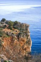Breathtaking Cliffside View of the Mediterranean Sea with City Skyline. Antalya, Turkey photo