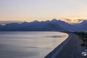 Tranquil seascape with distant mountain range, clear blue sky, and serene atmosphere. Antalya, Turkey photo