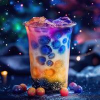 A colorful drink with a straw in it is sitting on a table. Cosmic galaxy tea photo