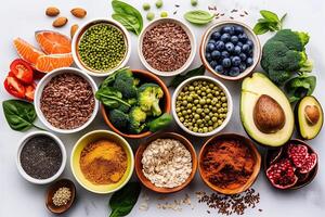 Assortment of superfoods with vibrant fruits, vegetables, and seeds on a white background for a healthy diet photo
