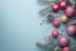 Chic Christmas composition with pink and silver ornaments on a soft blue background photo